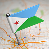 Djibouti Small Flag on a Map Background.