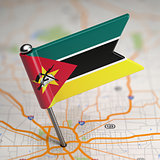 Mozambique Small Flag on a Map Background.