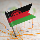 Malawi Small Flag on a Map Background.