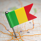 Mali Small Flag on a Map Background.