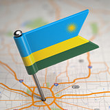 Rwanda Small Flag on a Map Background.