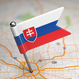 Slovakia Small Flag on a Map Background.