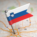 Slovenia Small Flag on a Map Background.