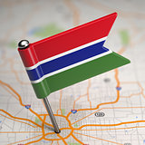 Gambia Small Flag on a Map Background.