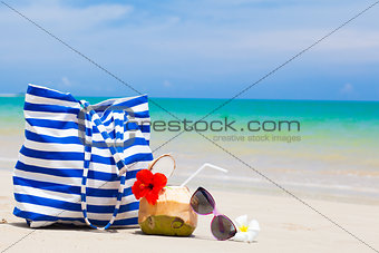 beach bag, sunglasses and coconut cocktail at tropical beach. Thailand, KhaoLak