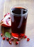 glass of fresh pomegranate juice from organic fruits