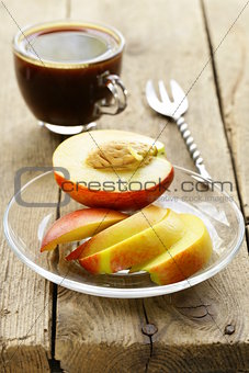fresh sliced ​​peach with a cup of coffee for breakfast