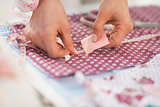 Closeup on seamstress making marks on fabric