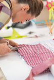 Seamstress cutting fabric