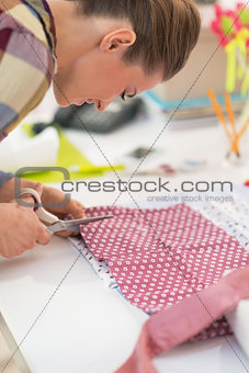 Seamstress cutting fabric