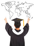 graduation man wearing a mortarboard and point to world