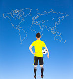 soccer player holding a soccer and looking global map