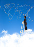 Business man standing a stepladder and drawing  global map