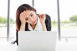 young business woman feel tired and holding head