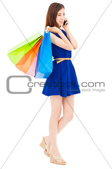  happy young  woman holding shopping bags and talking