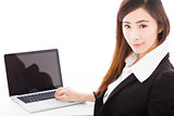 young businesswoman sitting and using a laptop