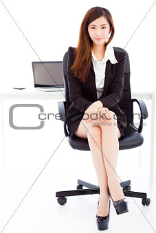 young confident business woman sitting in her office