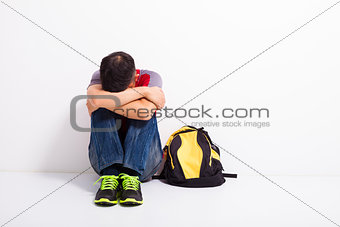 terrified student  sitting on the floor 