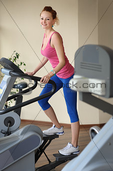young girl doing step machine workout