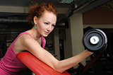 Slim girl doing biceps training