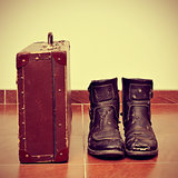 old suitcase and worn boots