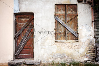 Boarded up window and old door