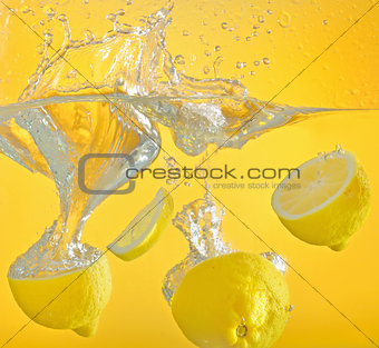 lemon thrown into the water with splash
