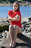 girl badly frozen sitting on a rock