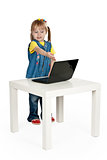little girl with a laptop at a table