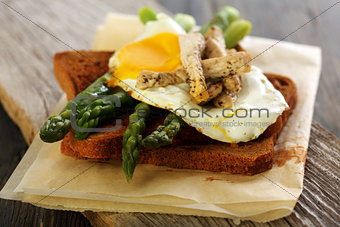 Toast with green asparagus and egg.