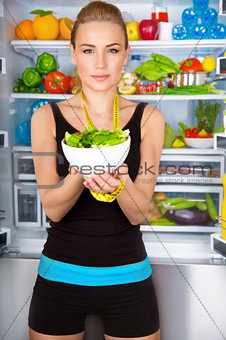 Healthy woman with fresh salad