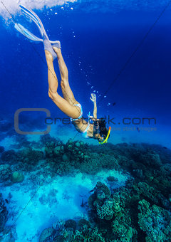 Woman diving to the sea bottom