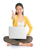 Asian girl using laptop pc and thumb up
