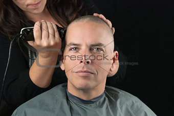 Stylist Shaves Mans Head