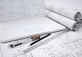 Scrolls engineering drawings and laptop