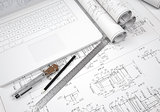 Scrolls engineering drawings and laptop