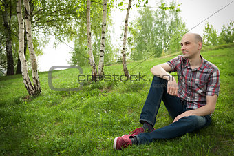  young man relaxing in summer park