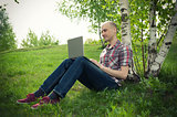 young man with laptop outdoor