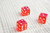 red dice on the financial newspaper
