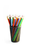 colored pencils in a container on white background