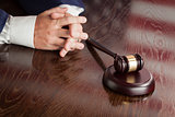 Judge Rests Hands Behind Gavel with American Flag Table Reflecti