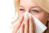 Ill woman with tissue is sneezing