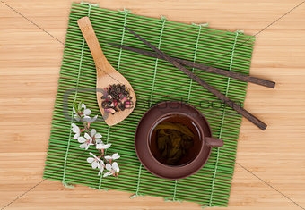 Japanese green tea and sakura branch