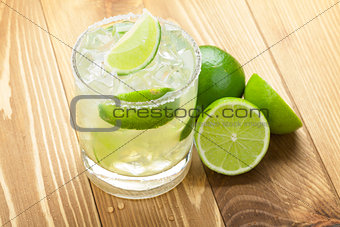 Classic margarita cocktail with lime and salty rim