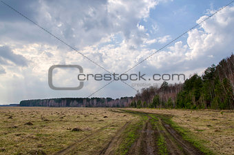 Spring landscape with a road and clouds