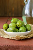green marinated olives in bowl on a wooden table