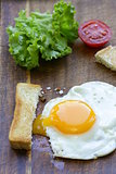 fried egg with fresh vegetables and toast for breakfast