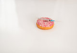 Closeup on donut and diabetes syringe on table