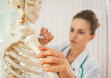 Closeup on medical doctor woman teaching anatomy using human ske