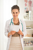 Portrait of happy medical doctor woman with tablet pc